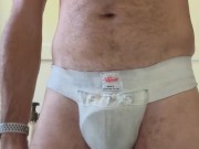 Stud sniffs filthy nut cup and adds cum to it