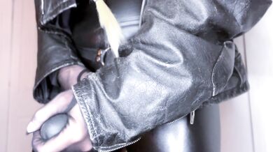Leather clad mistress teases her juicy ass with a flogger while gagging on solo session