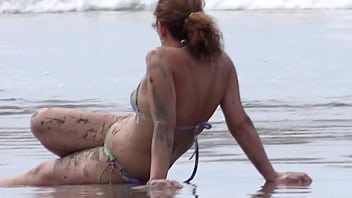 On the beach, my stepson films me while I show off and get hard.