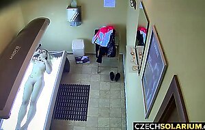 Blonde girl caught in public solarium,