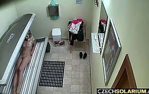 Blonde girl caught in public solarium,