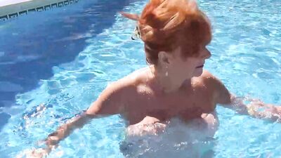 Aunt Judy's - Busty Mature Redhead Melanie goes for a Swim in the Pool