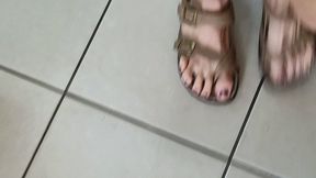 Walking in tan sandals and calves
