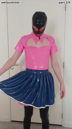 Putting on blue latex skirt over pink rubber maid dress and stockings, layers