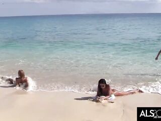 Sexy lesbian babes are undressed and enjoying on the beach, whilst people are staring at 'em