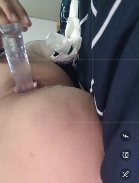 A cute Asian crossdresser in white stockings plays with her anus with a crystal penis