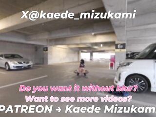 crossdresser doing an exhibition play in a parking lot