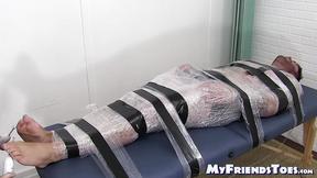 ”Restrained hunk endures tickling torment from his dom”