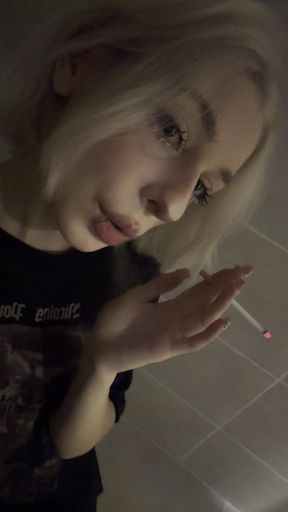 Teen petite babe smokes a cigarette