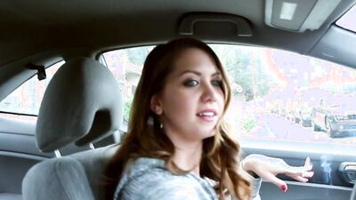 Chrissy Marie is smoking a cigar while driving a car