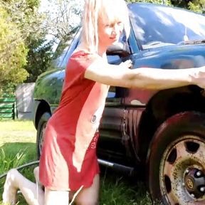 Sexy trans-girl car washing in red snoopy dress. Wetlook red dress