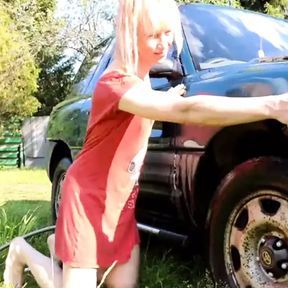 Sexy trans-girl car washing in red snoopy dress. Wetlook red dress