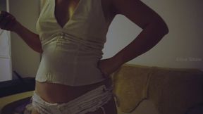 Pizza stuffing in a linen top and short white shorts