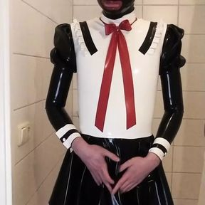 Latex maid uniform dress with black rubber skirt, red bow, frilly stockings and mask