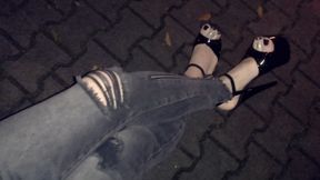 a crossdresser in high heels on a night walk
