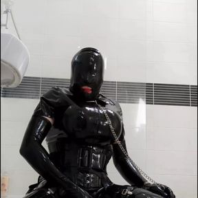 Alison in the bathroom dressed in rubber again