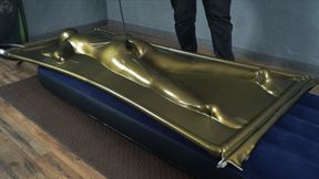 Ass flogging in a latex gold vacuum bed