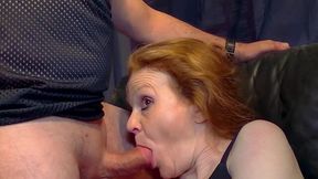 Mature redhead in stockings is sucking a hard penis with pleasure