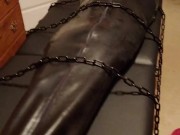 Hairless rubber gimp plugged and in chastity, training