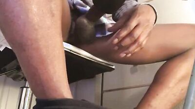 Black guy is filmed under the table while playing with his cock