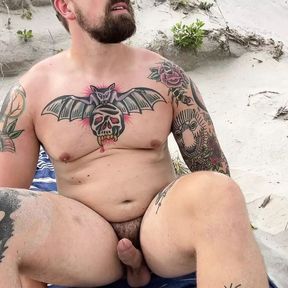 Rusty Taylor jerks big cock on the beach