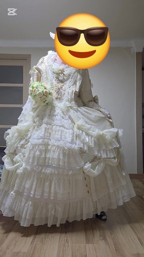 A man dressed as a woman dances in a dress.