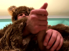 Muscled furry takes off his bear suit to fist-pump his hard cock