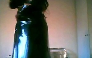 Spanish tgirl poses wearing a latex coat