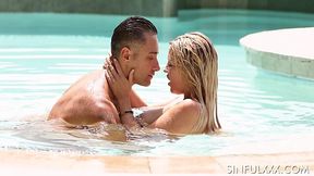 Just married couple is making love in the pool