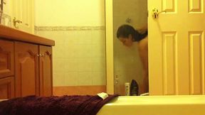 Worn out brunette takes off her clothes before heading to shower