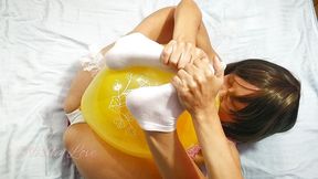 Fancy girl blow the yellow balloon and pop with her belly