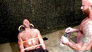 Soldier Dirk Caber takes all the painful shock from his big balls and naked nipples