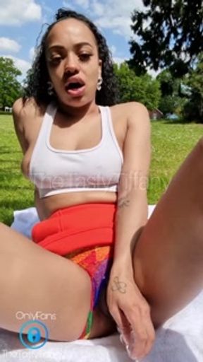 British mixed girl plays with her pussy in public park