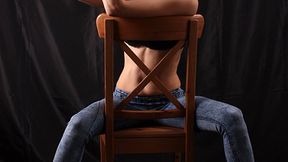 Anne: barefoot girl in black bra and blue skinny jeans, sitting on the chair with her hands tied up in front of her, poses for the camera (HD MOV)