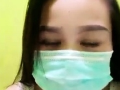 Playful Indonesian hottie wears a facemask while rubbing