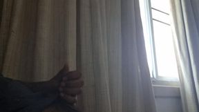 Sole asian male masturbating by the open window