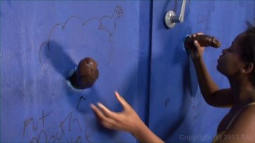 Black Babe Enjoys a Big Black Cock Through a Glory Hole