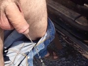 Soft cock pissing on side of road in public