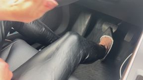 A girl in high-heeled shoes drives a car, presses the pedals with her shoes and drives