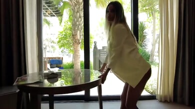 Monika Fox squirts on a glass table in a sunlit hotel suite
