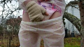 Diaper girl wets herself in public with transparent rain wear