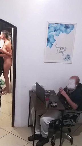 While the Husband Works, the Wife in a Towel Greets the Delivery Man