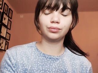 Brunette hair with natural large lips with natural color lipgloss smokin' a cigarette blowing smoke in your face