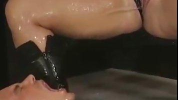Kinky ladies and one guy are wearing latex costumes and peeing all over each other