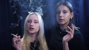 Two Women Smoking Together in a Dark Studio with Soft Blue Lighting