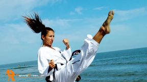 Alison taekwondo kicking action on the beach