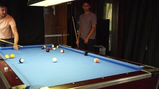Two men with big cocks are banging a lad on the table