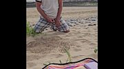 Desperate beach pee, while being watched