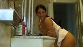 Awesome brunette chick masturbates her pussy in the bathroom