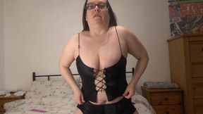 Playing with vibrator in black silk lingerie and stockings
